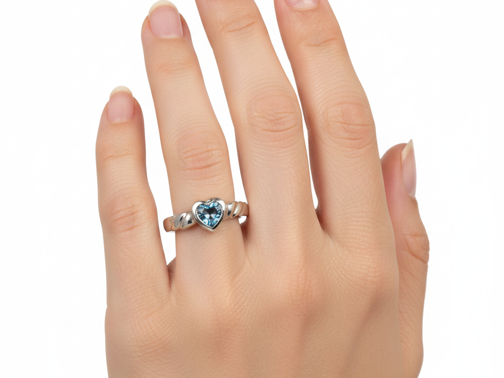 A Kids Aqua Cz Silver Heart Shaped Ring.