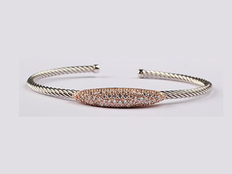 A Rose Plated White Cubic Zirconia Stone Set Silver Bangle.
