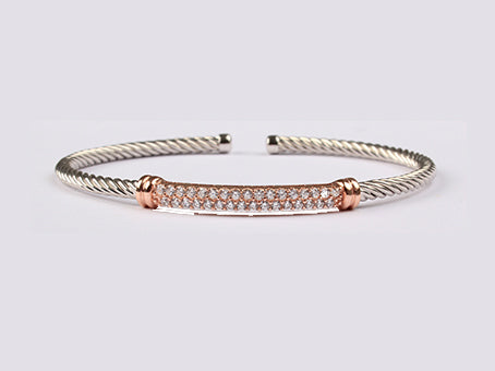 A Rose Plated White Cubic Zirconia Stone Set Silver Bangle.