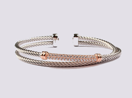 A Rose Plated White Cubic Zirconia Stone Set Silver Bangle.