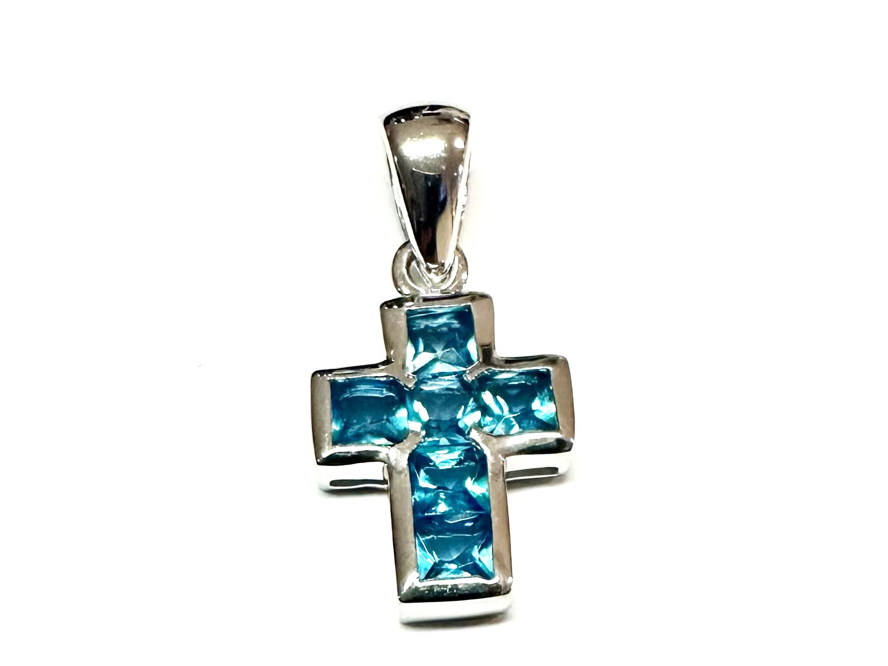 A Aquamarine & White Cubic Zirconia Cross Pendant.