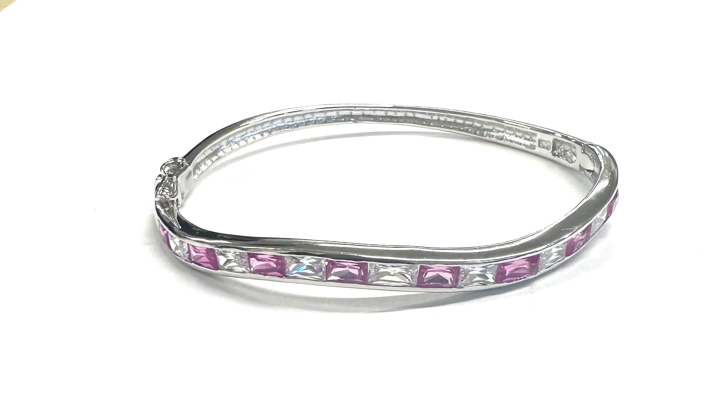 Ruby And White Cubic Zirconia Silver Twist Design Bangle.