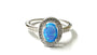 A Blue Opal And White Cubic Zirconia Ring