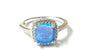 A Blue Opal And White Cubic Zirconia Ring