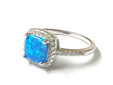 A Blue Opal And White Cubic Zirconia Ring